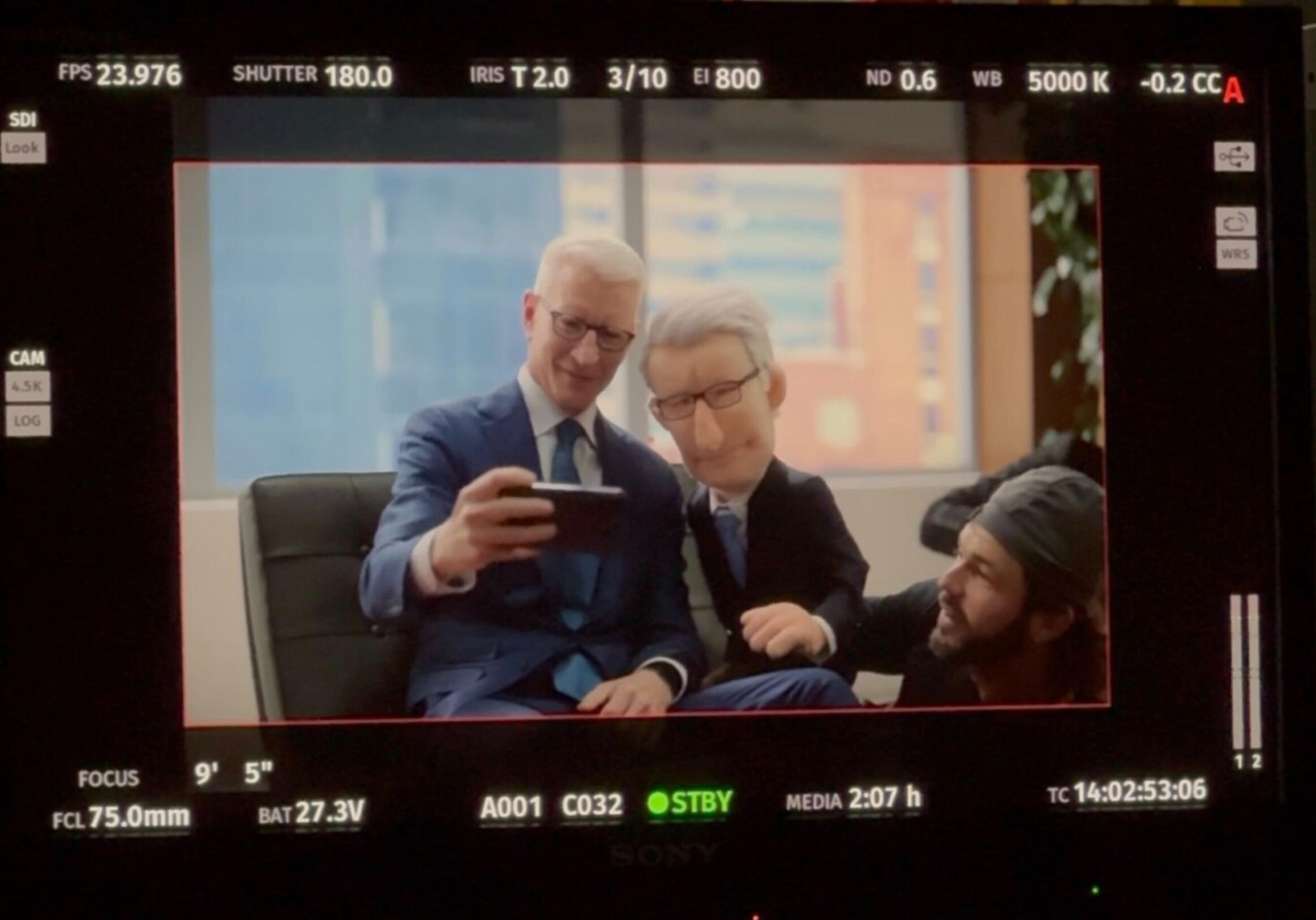 Puppet of Anderson Cooper, and Anderson Cooper himself, taking a selfie together on a set of a CNN photoshoot.